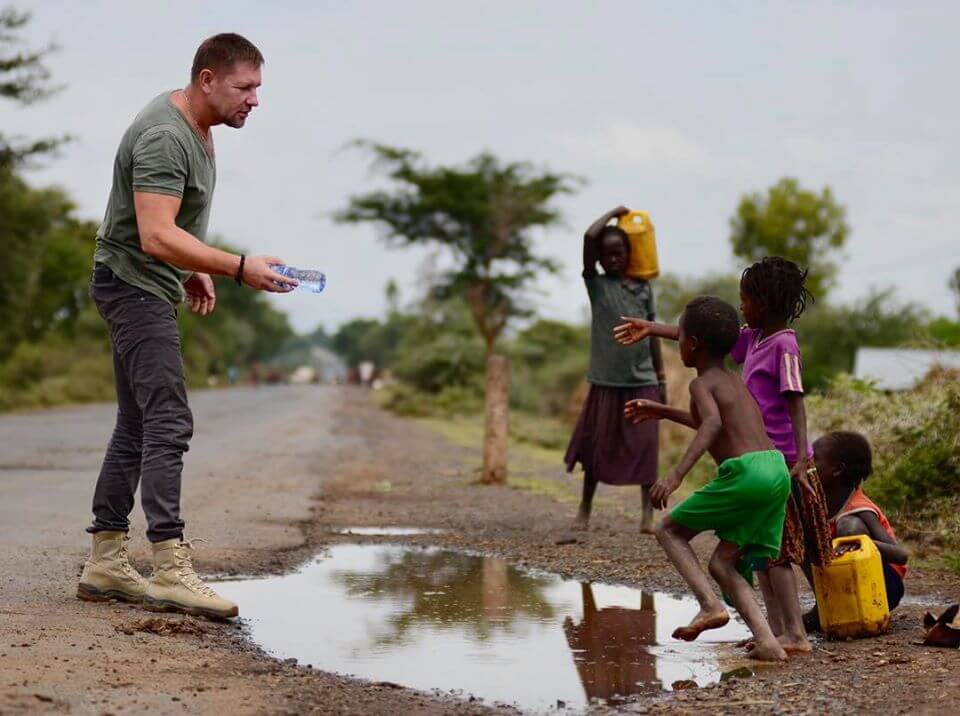 William walking with group on dirt road